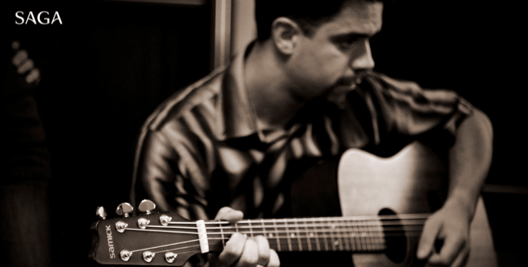 A black and white image of Captain Franko playing his own guitar